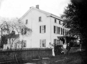 Henry Muhlenberg House, 201 W. Main Street, c. 1890. This photograph shows the west side of the house in which Henry and Mary Muhlenberg lived from 1776 to 1787. About 1863, the roofline was raised four feet to add a third story to the house. The people depicted here are probably members of the Hunsberger family, who owned the property from 1848 to 1895. (Courtesy of the Historical Society of Trappe, Collegeville, Perkiomen Valley.)